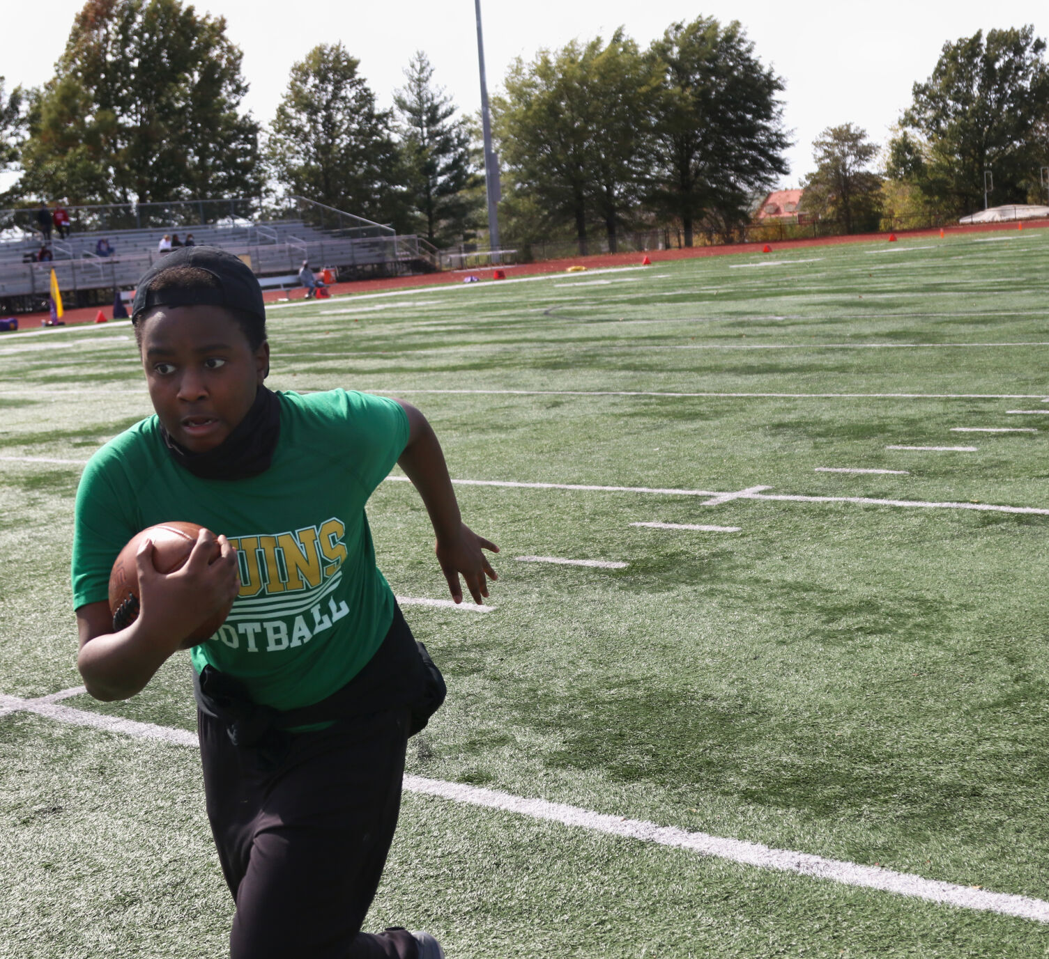 Joseph Jones, 13, runs with the ball after catching a pass from a friend